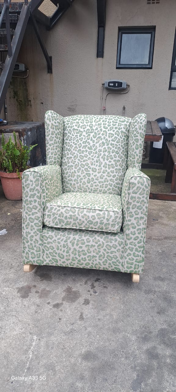 Green patterned wingback armchair